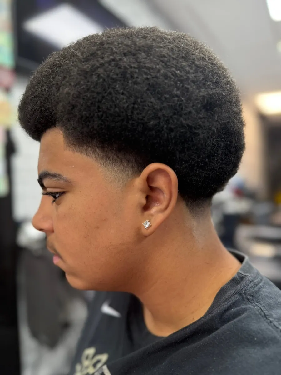 Back view of a taper fade haircut with a long flowing top by an expert Denver barber